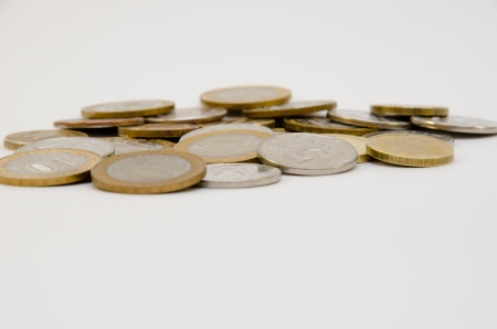 Heap of coins isolated on white backgroundの写真素材
