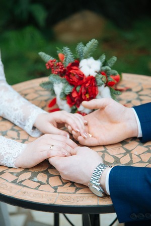 Detail of bride's roses bouquet and hands holdingの写真素材