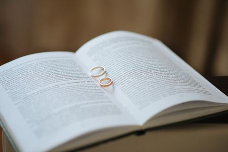 wedding rings among the pages of a bookの写真素材