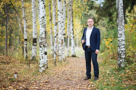 portrait of middle aged businessman walking in the natureの写真素材