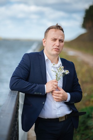 portrait of middle aged businessman walking in the natureの写真素材