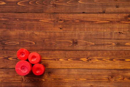 Four red candles on brown wooden table, top viewの写真素材
