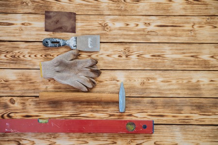 Old hand tools table. Old rusty and dirty hand tools lying on a wooden table background.の写真素材