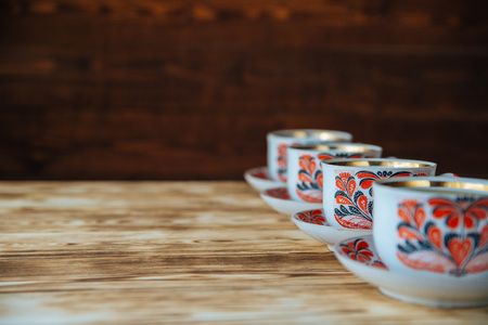 tea mug with red ornaments on old wooden tableの写真素材