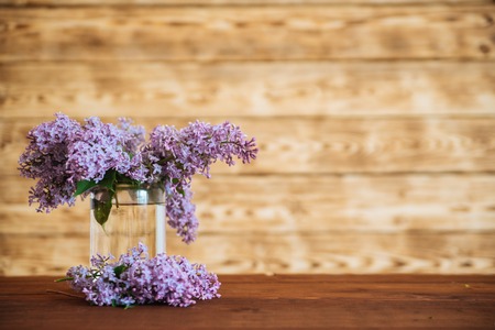 lilac in glass jar on wooden background, selective focusの写真素材