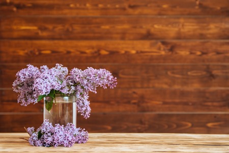 lilac in glass jar on wooden background, selective focusの写真素材