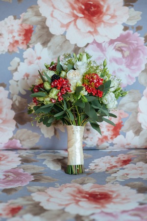 Beautiful wedding colorful bouquet for bride. Beauty of colored flowers. Close-up bunch of florets. Bridal accessories. Female decoration for girl. Details for marriage and for married coupleの写真素材