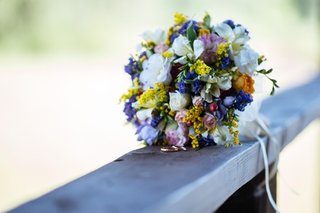 Beautiful wedding colorful bouquet for bride. Beauty of colored flowers. Close-up bunch of florets. Bridal accessories. Female decoration for girl. Details for marriage and for married coupleの写真素材