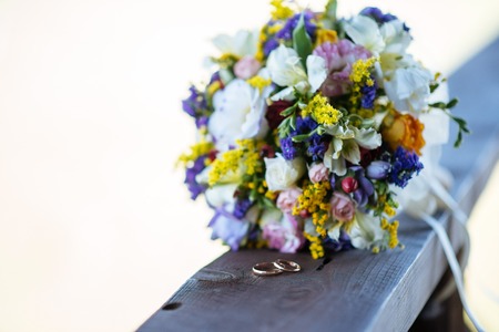 Beautiful wedding colorful bouquet for bride. Beauty of colored flowers. Close-up bunch of florets. Bridal accessories. Female decoration for girl. Details for marriage and for married coupleの写真素材