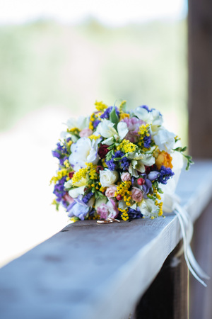 Beautiful wedding colorful bouquet for bride. Beauty of colored flowers. Close-up bunch of florets. Bridal accessories. Female decoration for girl. Details for marriage and for married coupleの写真素材