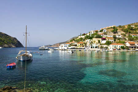 a sailing boat moored in calm waters of the bay of Assos in Cephalonia in Greeceの写真素材