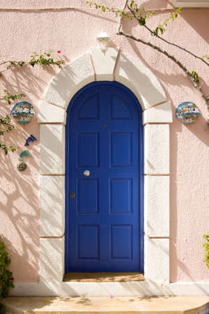 blue front door of a typical house in greek style, in Assos, a village on the island of Kefalonia.の写真素材