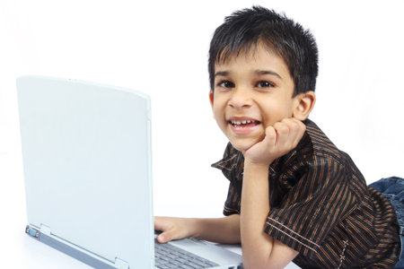 Cheerful Indian Boy using laptop
