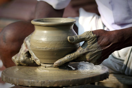Indian Potter Taking The Finished Pot Off The Wheel