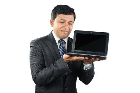 Young Businessman looking depressed with Laptopの写真素材