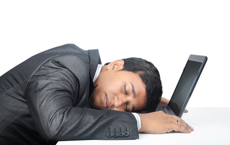 Indian Businessman Sleeping over the laptopの写真素材
