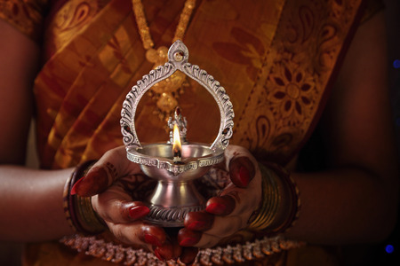 Indian Girl Holding kamatshi Amman Oil Lampの写真素材