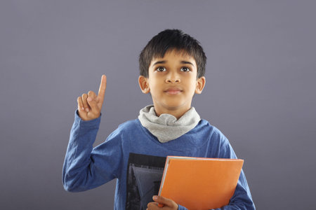 Portrait of Indian School Boy with Textbook