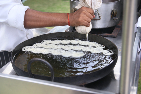 Indian Chef cooking the traditional sweet Jhangri or jalebiの写真素材