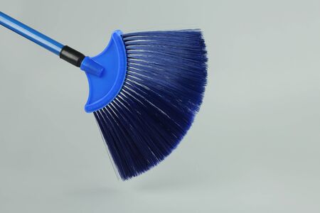 Plastic broom stick isolated on gray backgroundの写真素材