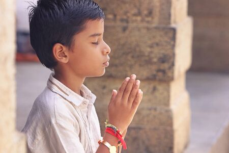 Indian Cute Little Boy Prayingの写真素材