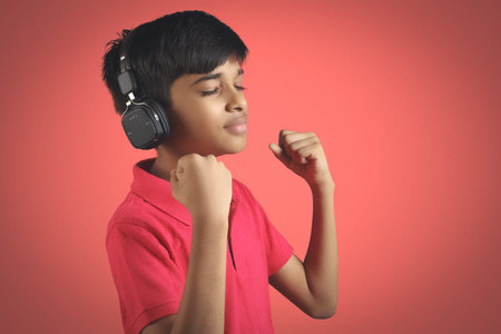 Indian young boy listen music with headphone