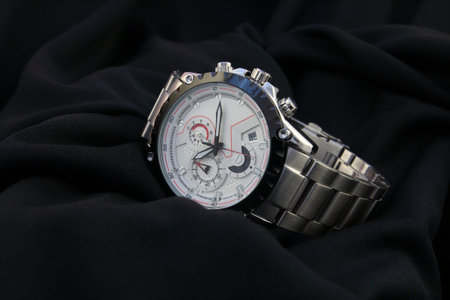 Men's wrist metal watch on black background