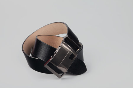Black leather belt isolated on gray background