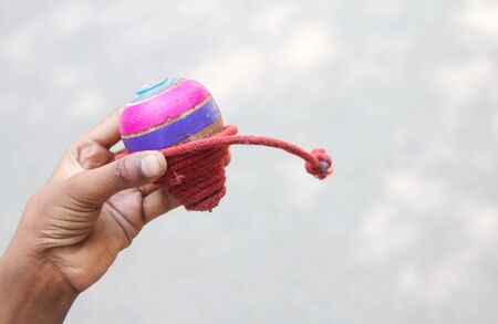 Classic wooden spinning top toy with stringの写真素材