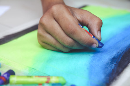 Portrait of boy drawing using color pencils and crayons