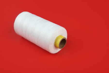 bobbin thread isolated on red background