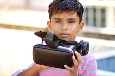 Portrait Indian little boy holding Virtual Reality Glasses