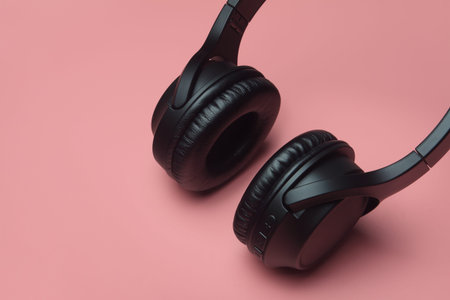 Professional wireless headphones isolated on pink background