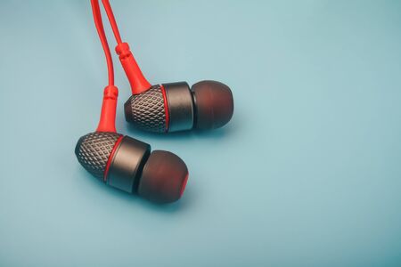 Earphones lying on the blue backgroundの写真素材