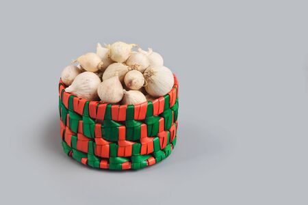 Indian traditional single clove garlics in basketの写真素材