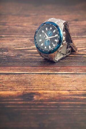 Men's wrist metal watch on wooden tableの写真素材