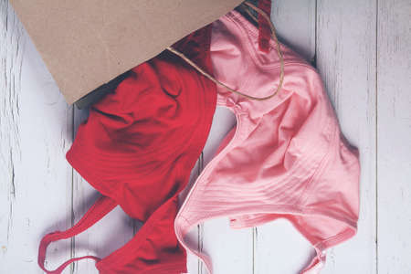 Woman's Bra with shopping bag on wooden Backgroundの写真素材