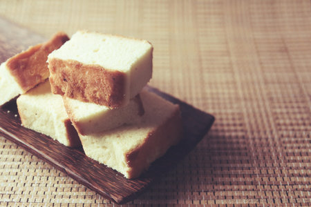 Home made fresh sponge sliced cakes on wooden tray