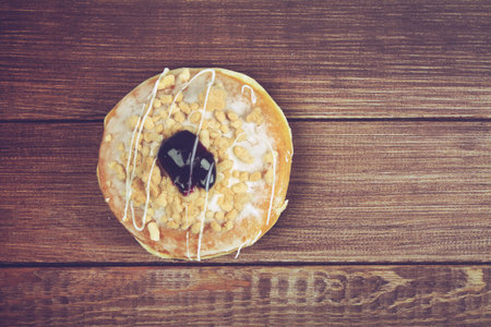 Delicious glazed doughnuts on wooden table