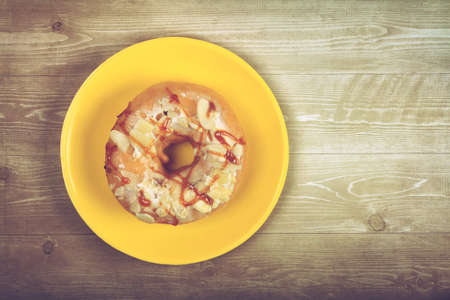 Delicious glazed doughnuts on wooden tableの写真素材