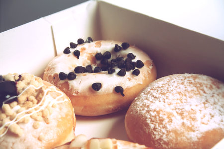 Assorted donuts with different fillings in cardboard boxの写真素材