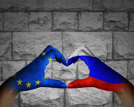 flags of Russia and the Europe at the hands folded in the shape of heartの写真素材