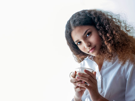 young girl holding a cup of coffee