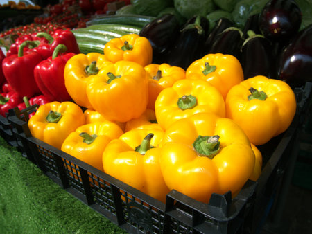 Yellow peppers on sale on a market stallの写真素材
