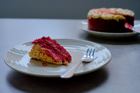 Slice of Red Velvet Cake with a fork on a white plate.