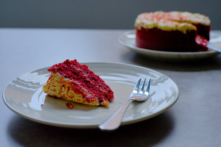 Slice of Red Velvet Cake with a fork on a white plate.