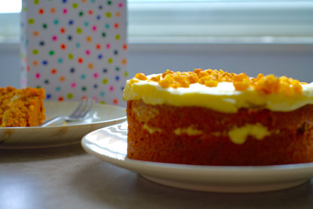Slice of Carrot Cake with a fork on a white plate.