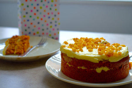 Slice of Carrot Cake with a fork on a white plate.