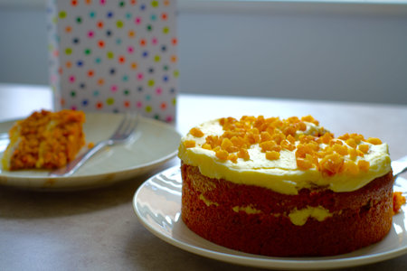 Slice of Carrot Cake with a fork on a white plate.