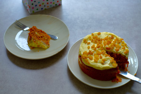 Slice of Carrot Cake with a fork on a white plate.